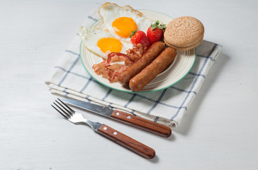 Nutritious breakfast, strawberry, bread, coffee orange juice, sausage, egg