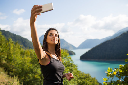 Young woman taking pictures on the phone