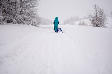 Small boy on a mountain covered with snow. Love. Passion. Persistent desire.
