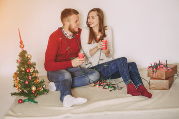 loving couple decorating Christmas tree