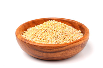 Pearl barley in wooden bowl isolated.
