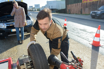 man fixing a car problem after vehicle breakdown