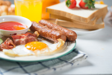 Nutritious breakfast, strawberry, bread, coffee orange juice, sausage, egg