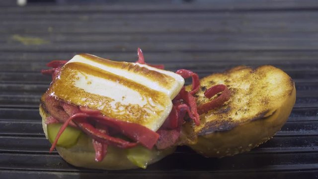 Kumru is a traditional Turkish sandwich on a bun, typically with cheese, tomato, and sausage. Street Food in Izmir Cesme.