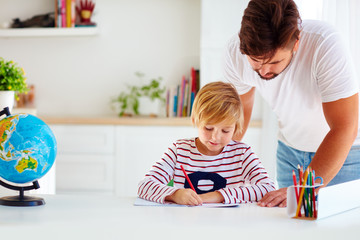father and son at the desk, educating at home
