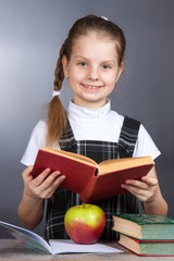 girl smiling girl holds in her hands an open book.