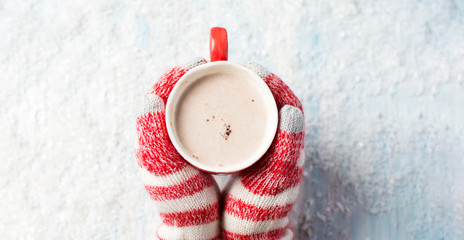 female hands in gloves holding hot chocolate - 174998730