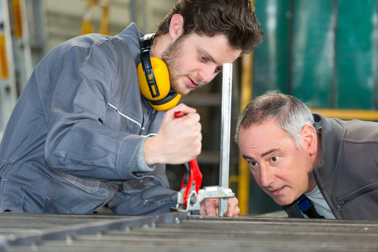 young apprentice with professional metallurgist