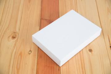 Empty white gift on wooden table with copy space.