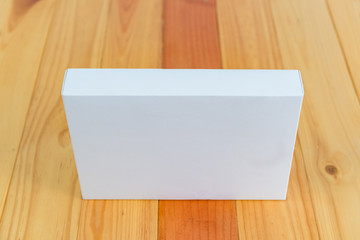 Empty white gift on wooden table with copy space.