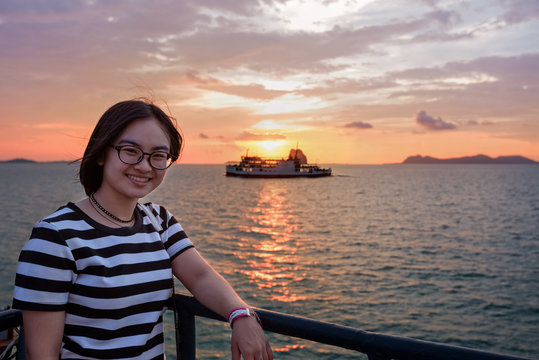 Beautiful nature of colorful sky and sun at sunset over the sea, women tourist on the deck of a large passenger boat while cruising to Koh Samui Island in Surat Thani province, Thailand