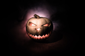 Fototapeta premium Halloween - old jack-o-lantern on black background. Closeup of scary halloween pumpkins