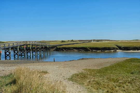 Boardwalk over Marsh heading toward beach on clear day