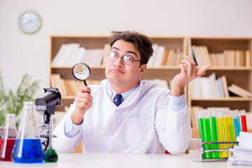 Mad crazy scientist doctor doing experiments in a laboratory