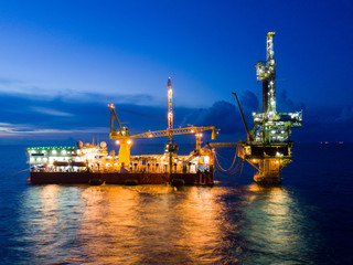 Aerial View of Tender Drilling Oil Rig (Barge Oil Rig) in The Middle of The Ocean at Sunrise Time