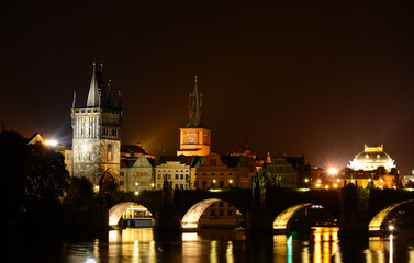 Night cityscape of Prague old town, its towers, Vltava river, Charles bridge and Opera House