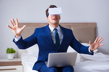 Businessman wearing a virtual reality headset in the bedroom