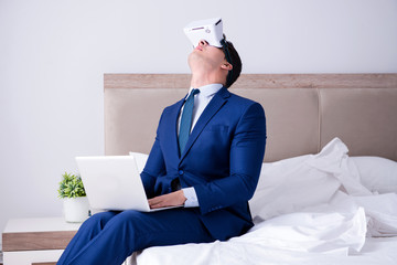 Businessman wearing a virtual reality headset in the bedroom