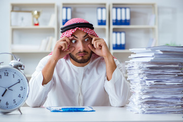 Arab businessman working in the office doing paperwork with a pi
