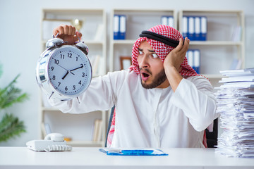Arab businessman working in the office doing paperwork with a pi