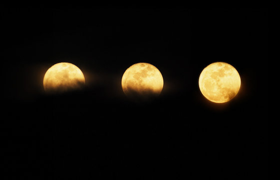 Set of full moon over dark night sky
