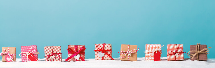Collection of Christmas gift boxes in a snow covered landscape