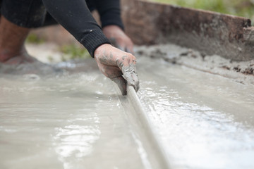 labor plastering cement with trowel for build new floor for renovation house