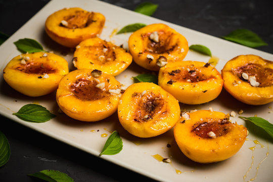 Grilled peaches on the rustic background. Shallow depth of field. Selective focus.