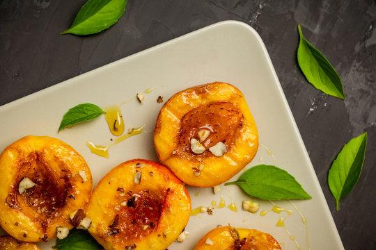 Grilled peaches on the rustic background. Shallow depth of field. Selective focus.