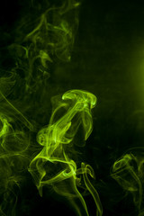 Green smoke on a black background.