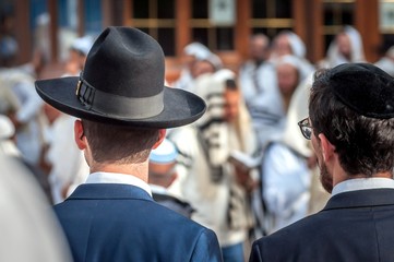 Two adult Hasidim in traditional Jewish headdresses hat and kippah. Prayer of Hasidim.