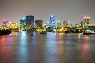 Fototapeta premium Night view of Business and Administrative Center of Ho Chi Minh city on Saigon riverbank in twilight, Vietnam. 