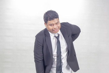 Fat businessman have  a backache
