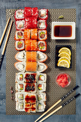 Menu of Japanese sushi rolls on black background