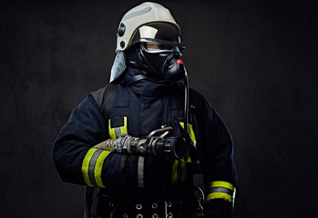 Fototapeta premium Firefighter dressed in uniform and an oxygen mask.