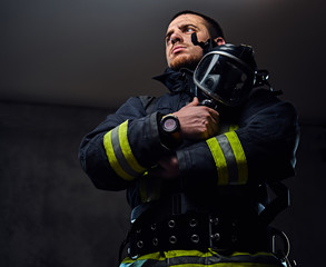 Naklejka premium Studio portrait of a male dressed in a firefighter uniform.