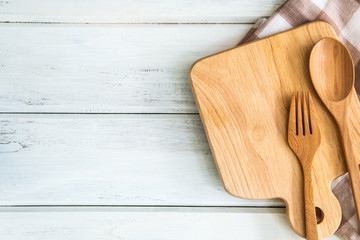 chopping board with wooden fork and spoon on white table , recipes food  for healthy habits shot note background concept