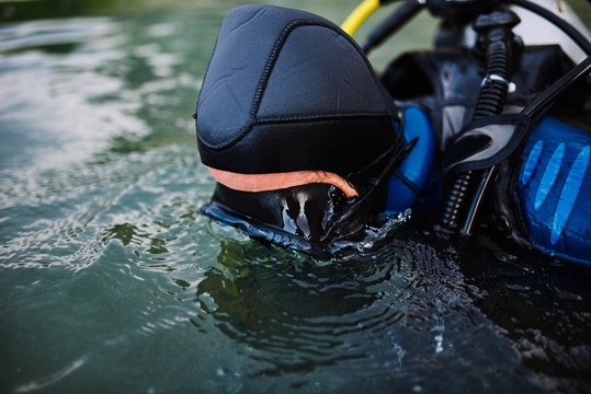 Diver in swimming mask looking underwater