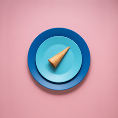 Dinner is served / Creative concept photo of kitchenware, painted plate with food on it on pink background.