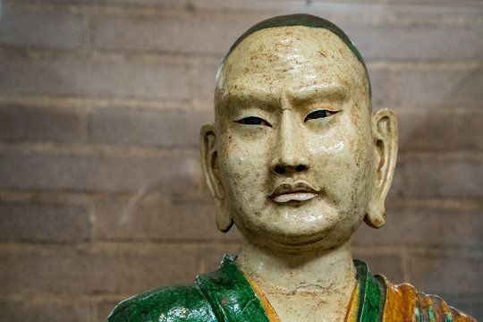 old luohan monk statue face detail