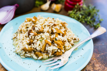 Risotto with chanterelle mushrooms and herbs. Italian food.