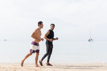 Two Men Jogging On Beach Together Guys Runners Training On Seaside Sport Fitness Workout Outdoors Healthy Lifestyle Concept