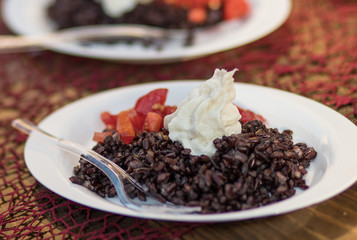 Black rice plate with tomato and ricotta cheese