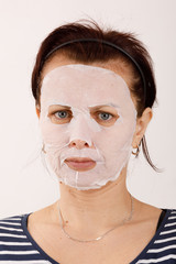 housewife woman with a sheet mask on her face
