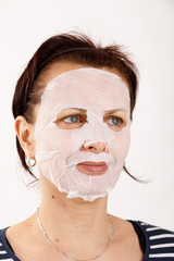 housewife woman with a sheet mask on her face