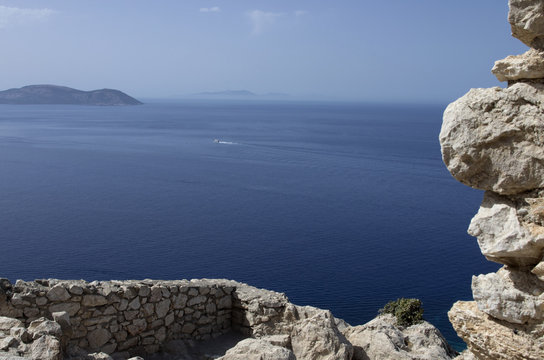 Ruins of the medieval castle of Kastellos in Kritinia with a beautiful view of the blue sea on the island of Rhodes (Greece).