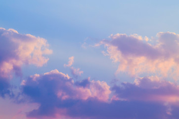 Beautiful sunset purple, magenta, yellow and blue sky with clouds and sunshine on a sunny day in summer