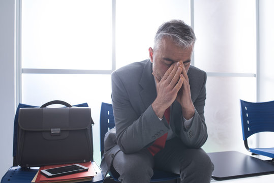 Depressed businessman in the waiting room