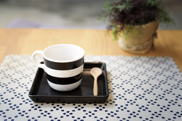 Well designed coffee cup on a wooden table in cafe