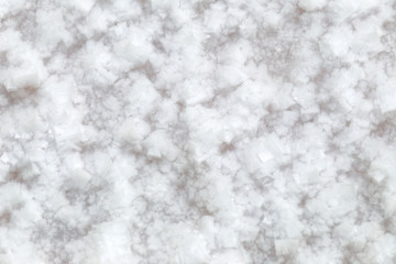 Sea salt mining, produced from the evaporation of seawater, close up background.
